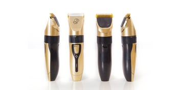 gold and black dog grooming clippers on a white background